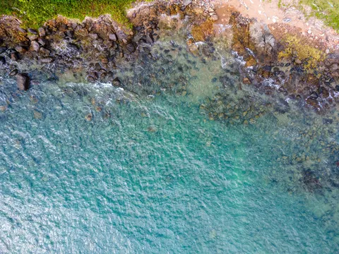 Turquoise water and a rocky Koh Chang headland seen from above.