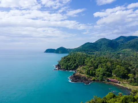 Long forested Koh Chang coastline with small islands on the horizon.