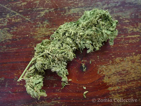 Dried Koh Chang cannabis flower resting on a wooden table.