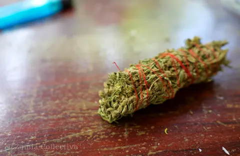 Close angled view of a locally produced Koh Chang Buddha stick on a wooden table.