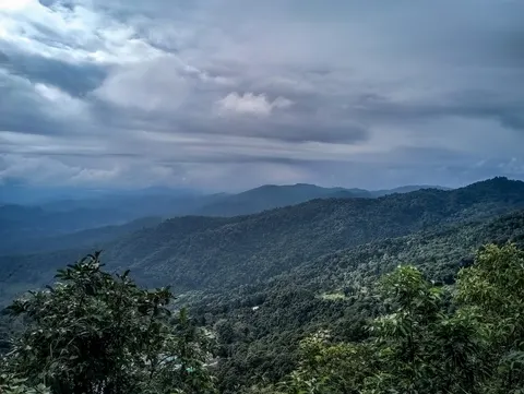 The same ridges under cloud, rain falling somewhere in the distance.
